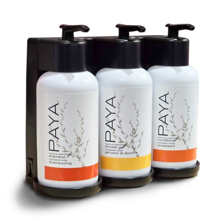 photo of paya three-chamber wall-mounted hotel dispenser set, with individual units for Shower Gel, Shampoo, and Conditioner.